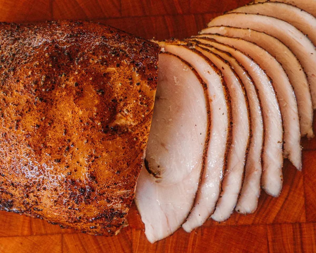 A smoked turkey breast, sliced at one end